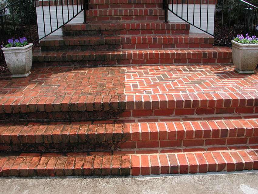 Brick steps half cleaned showing dramatic before and after contrast